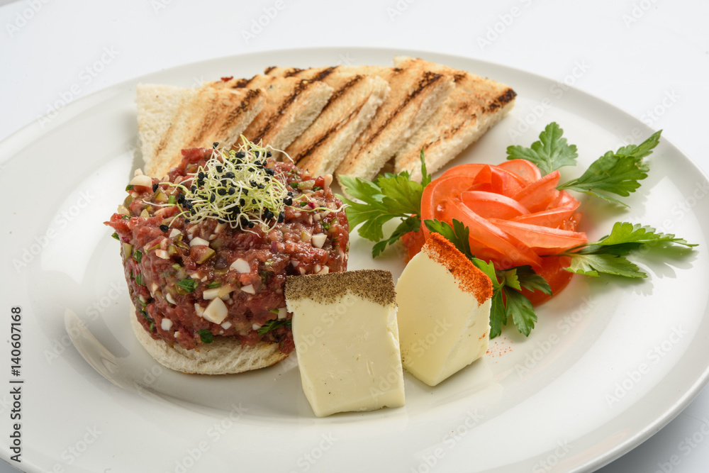 tasty Steak tartare (Raw beef) - classic steak tartare on white plate tasty Steak tartare (Raw beef) - classic steak tartare on white plate