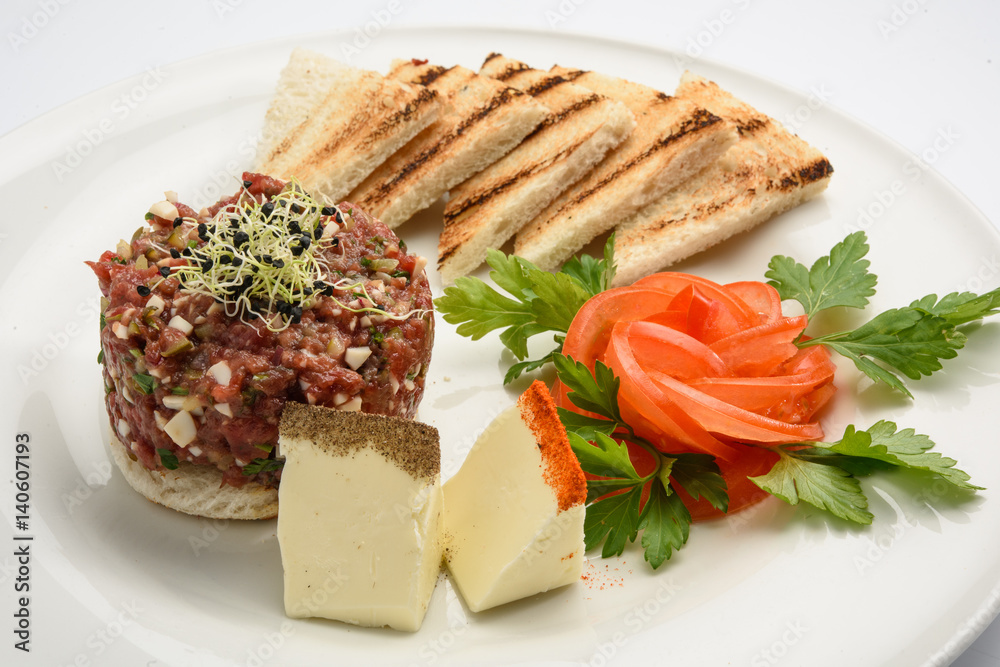 tasty Steak tartare (Raw beef) - classic steak tartare on white plate tasty Steak tartare (Raw beef) - classic steak tartare on white plate