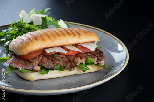 Obraz na płótnie grilled steak medium fresh baked ciabatta sandwich beer w salonie