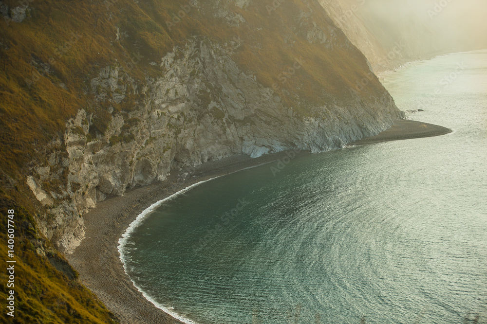 Fototapeta premium Jurassic coast showing secluded beach, with blue sea and white cliffs