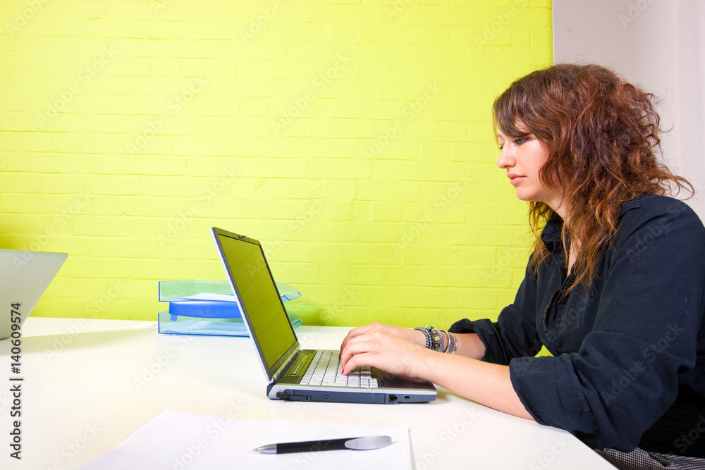 Side view of woman working at her computer Side view of woman working at her computer
