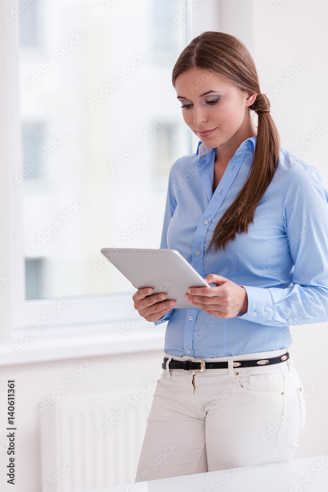 Beautiful businesswoman using tablet computer Beautiful businesswoman using tablet computer