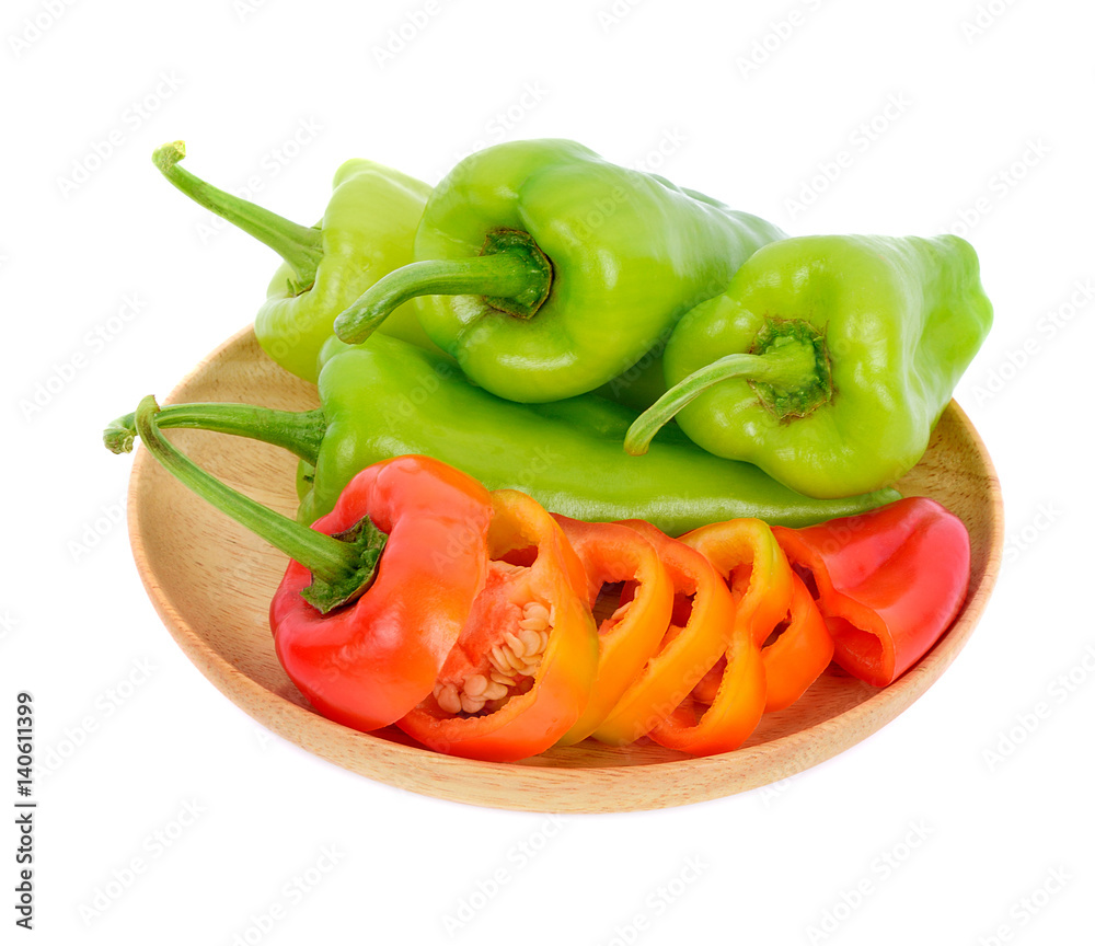 Sweet pepper in wooden dish isolated on white background Sweet pepper in wooden dish isolated on white background