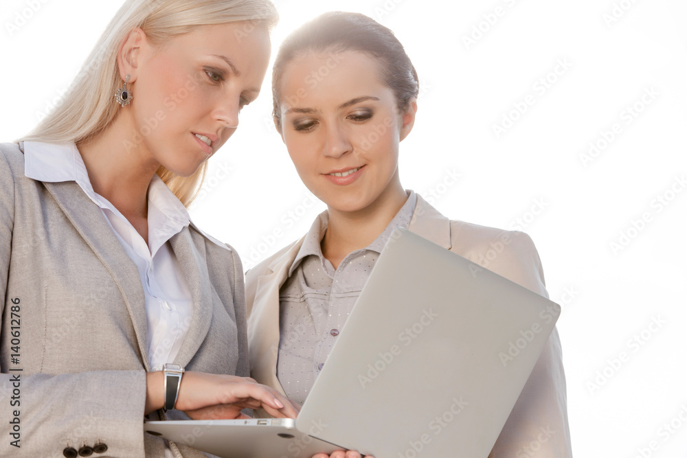 Young businesswomen using laptop against clear sky Young businesswomen using laptop against clear sky