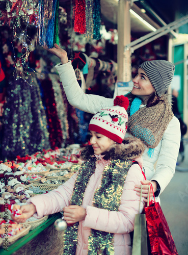 Smiling woman with small daughter in market