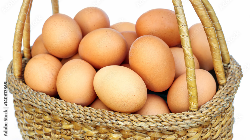 chicken eggs in a basket on white background. chicken eggs in a basket on white background.
