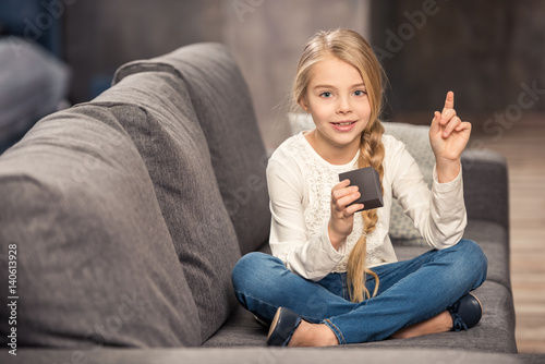 Girl playing with cube photo