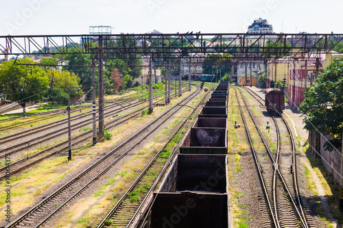 Empty freight train wagons stand on rails