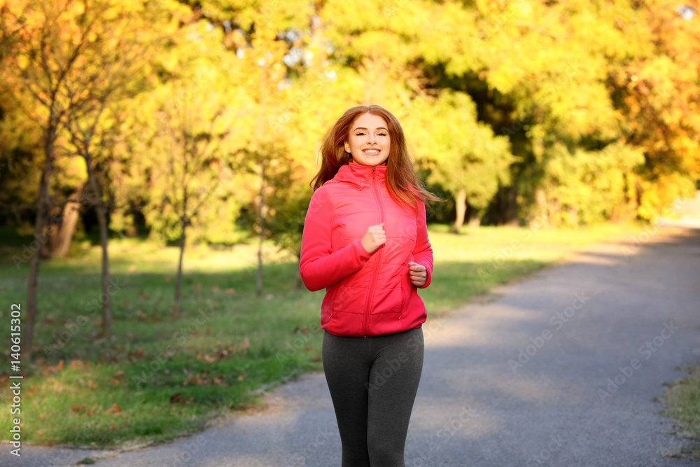 Young beautiful woman running in autumn park Young beautiful woman running in autumn park