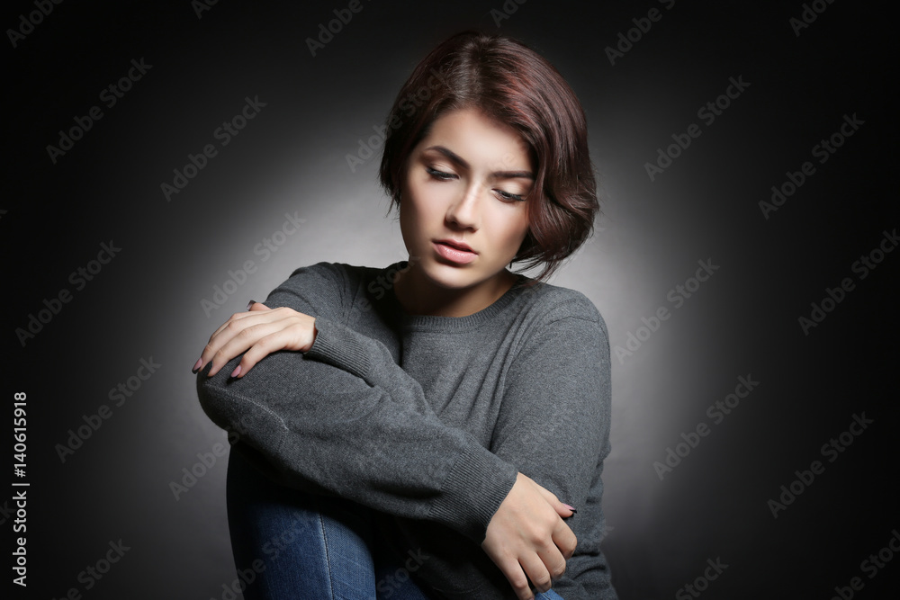 Depressed young woman on grey background Depressed young woman on grey background