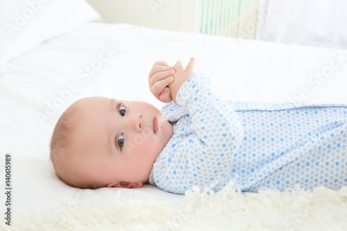 Cute baby lying on bed