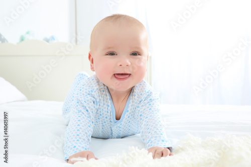 Cute baby lying on bed