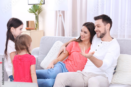 Happy family on sofa in the...