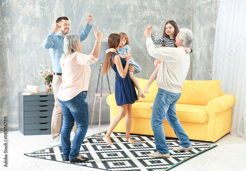Happy big family dancing in...