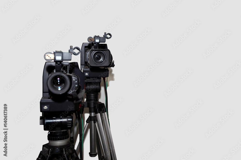Camera and tripod against white background