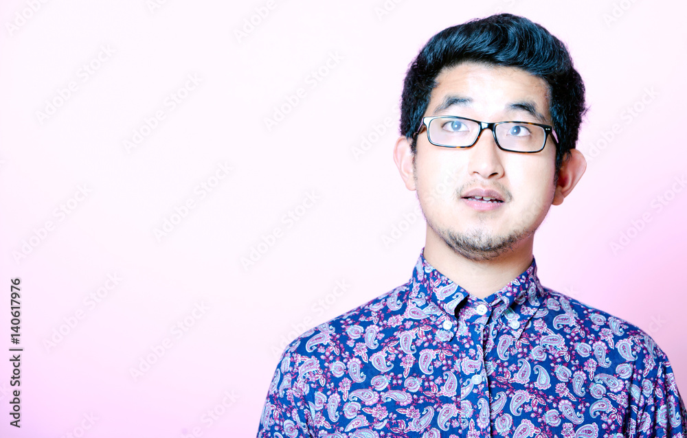 Fototapeta premium Young Geeky Asian Man in colorful shirt wearing glasses