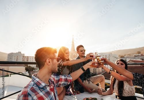 Photography Friends hanging out with drinks on rooftop party