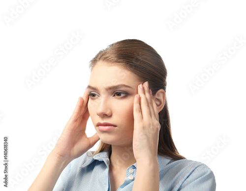 Beautiful young woman suffering from headache on white background