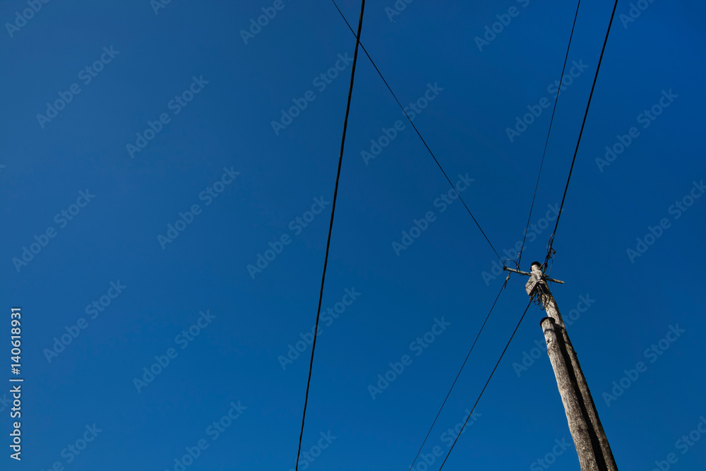 Low angle view of electric wires against clear blue sky Low angle view of electric wires against clear blue sky