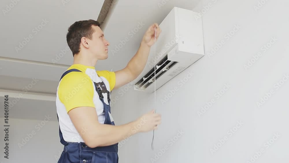 serviceman inspects and measures a air conditioning serviceman inspects and measures a air conditioning