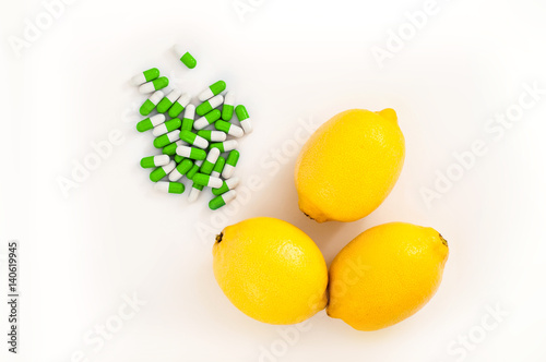 Three yellow lemons near medical pills as concept of healthy and alternative food