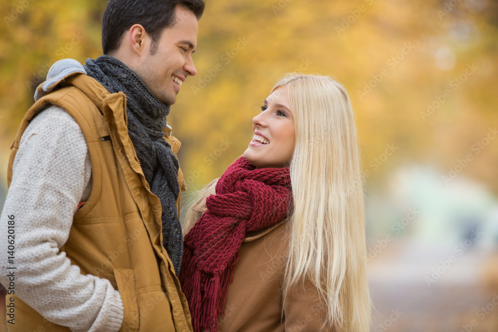 Happy couple looking at each other in park Happy couple looking at each other in park