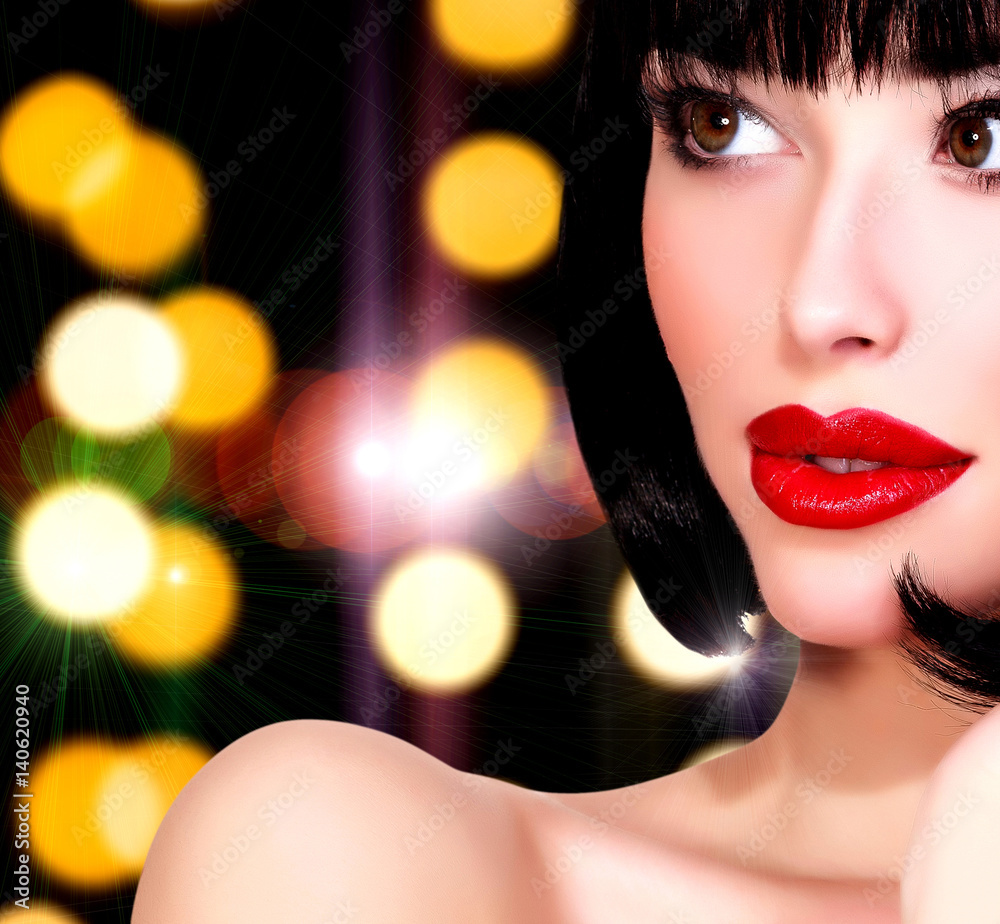 Pretty woman against an abstract background with blurred lights Pretty woman against an abstract background with blurred lights