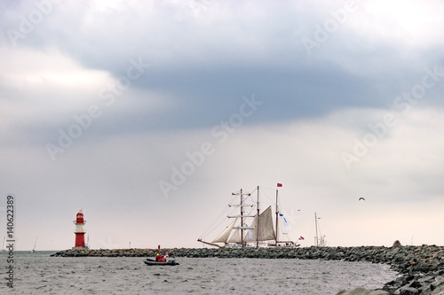 Sailing ship on the sea. Tall Ship and lighthouse Yachting travel. photo