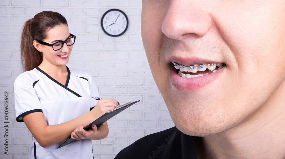 doctor and young man with braces on teeth doctor and young man with braces on teeth