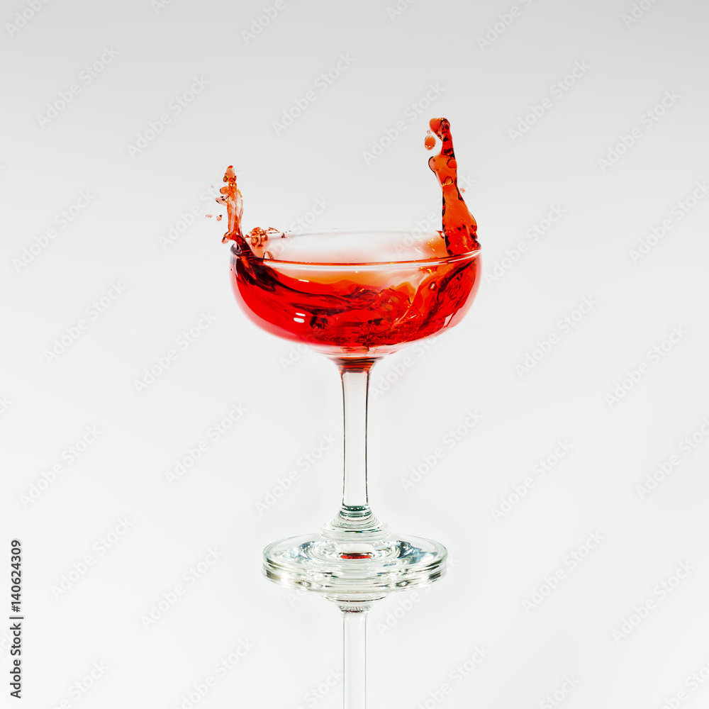 Wine glass with splash out red liquid Wine glass with splash out red liquid