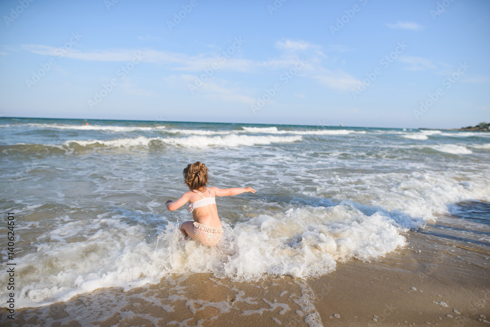 Girl Playing in Sea Waves