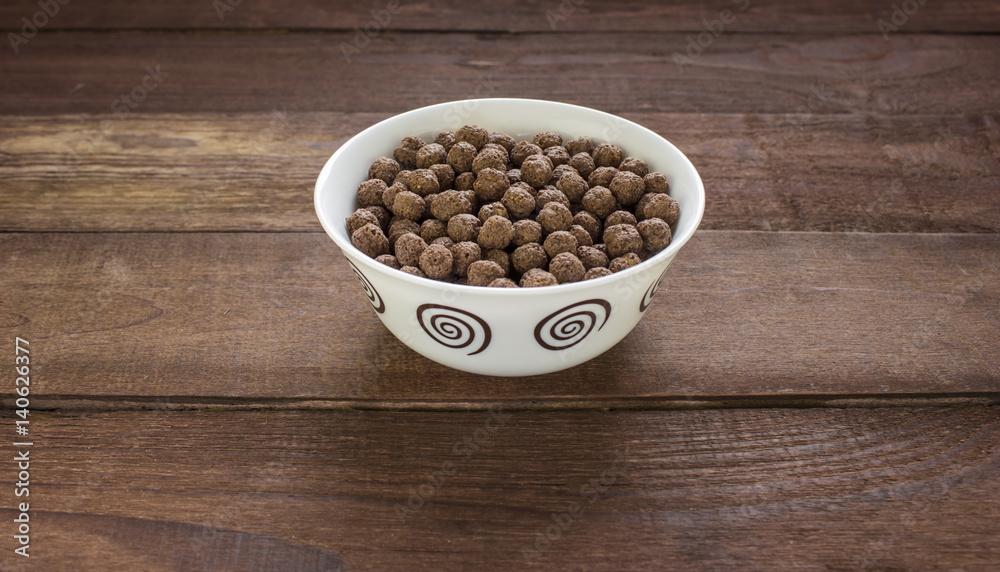 Bowl with chocolate balls on wooden table Bowl with chocolate balls on wooden table