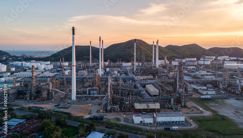 Aerial view Oil refinery with a background of mountains and sky.The factory is located in the middle of nature and no emissions. The area around the air pure.