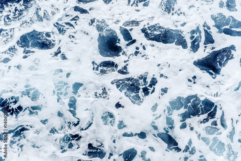 Atlantic ocean with blue water on a sunny day. Waves, foam and w Atlantic ocean with blue water on a sunny day. Waves, foam and w