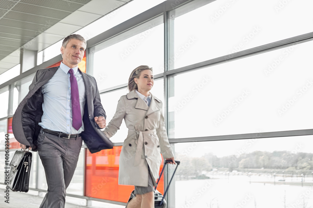 Businessman and businesswoman rushing in railroad station Businessman and businesswoman rushing in railroad station