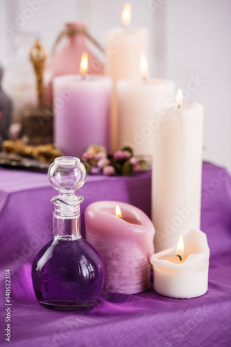 Bottles with essential aroma oil and aroma candles. Spa setting 