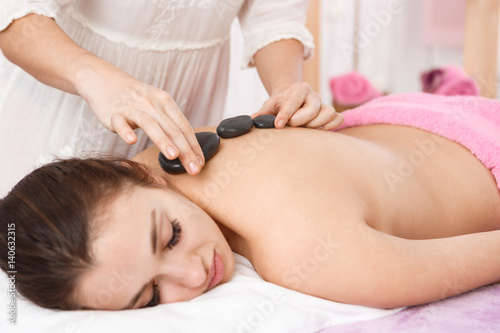 Εκτύπωση καμβά Masseur doing massage with hot stones on woman back