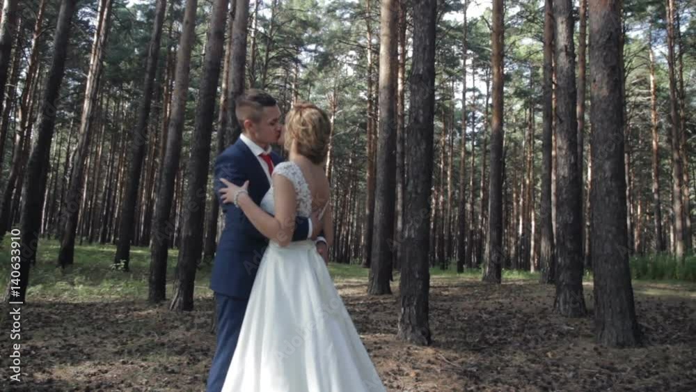 Bride and groom kissing in the forest Bride and groom kissing in the forest