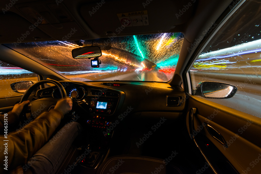 Night road view from inside car natural light street and other cars is motion blurred, during a rain Night road view from inside car natural light street and other cars is motion blurred, during a rain