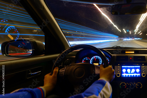 Night road view from inside car natural light street and other cars is motion blurred © narozhnii