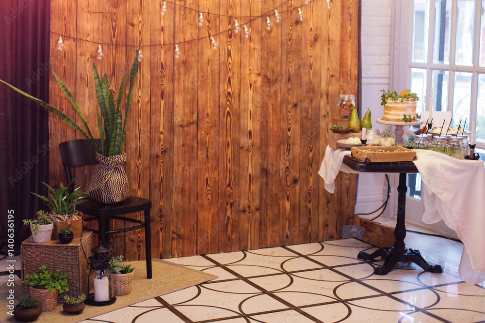 Obraz premium Zone for photo with sweet bar,greenery,retro bulbs,wooden background