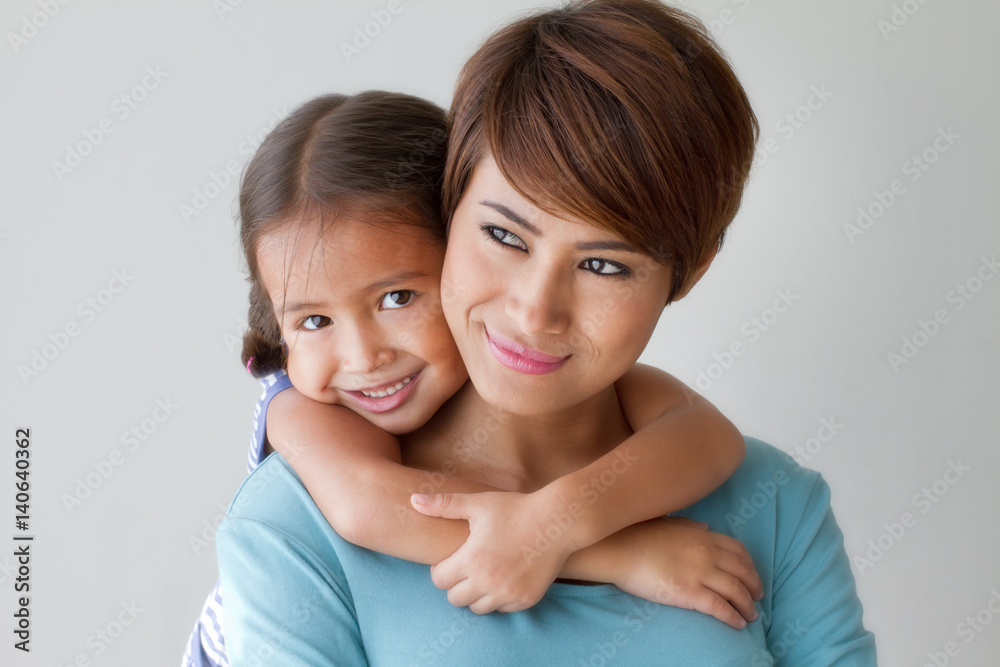 happy family with smiling, positive daughter hugging her mother happy family with smiling, positive daughter hugging her mother