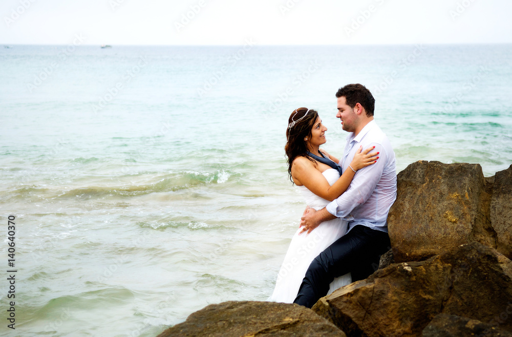 Grooms couple dating on the beach