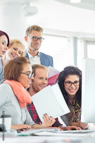 Business people using computer in creative office