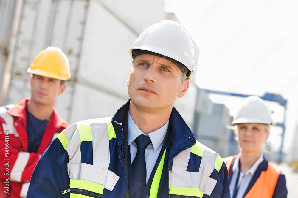 Team of confident workers in shipping yard Team of confident workers in shipping yard