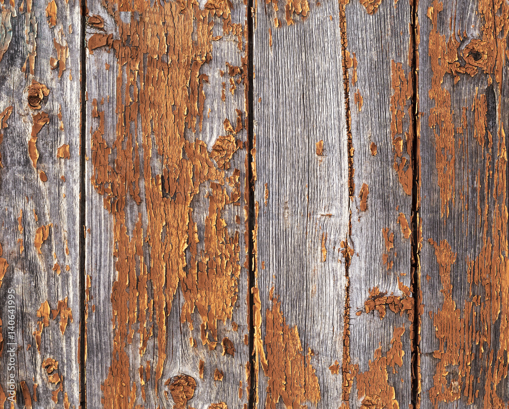 Old weathered red painted wooden wall with flaking off paint, seamless texture pattern
