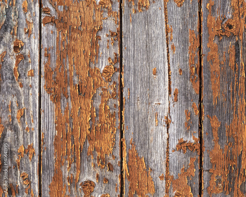 Old weathered red painted wooden wall with flaking off paint, seamless texture pattern