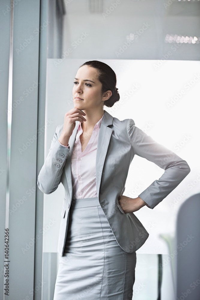Thoughtful young businesswoman in office Thoughtful young businesswoman in office