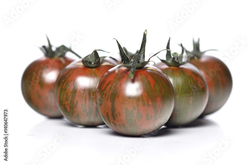 Black cherry tomatoes on white background