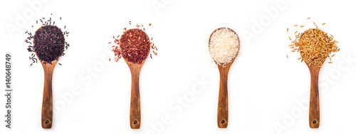 For different kind of raw rice in wooden spoon on white background